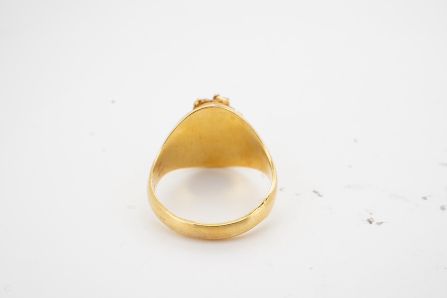 A gold signet ring, of textured design, to a tapering polished band, size N, stamped 10K, gross weight approximately 8 grams